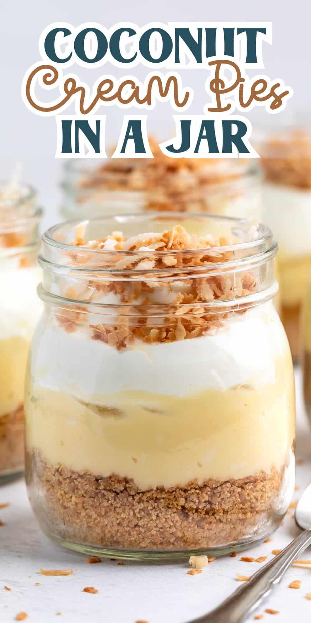 Three mason jars filled with layered coconut cream pie ingredients. Each jar has a crust layer, creamy filling, whipped topping, and toasted coconut flakes. The text above reads Coconut Cream Pies in a Jar.