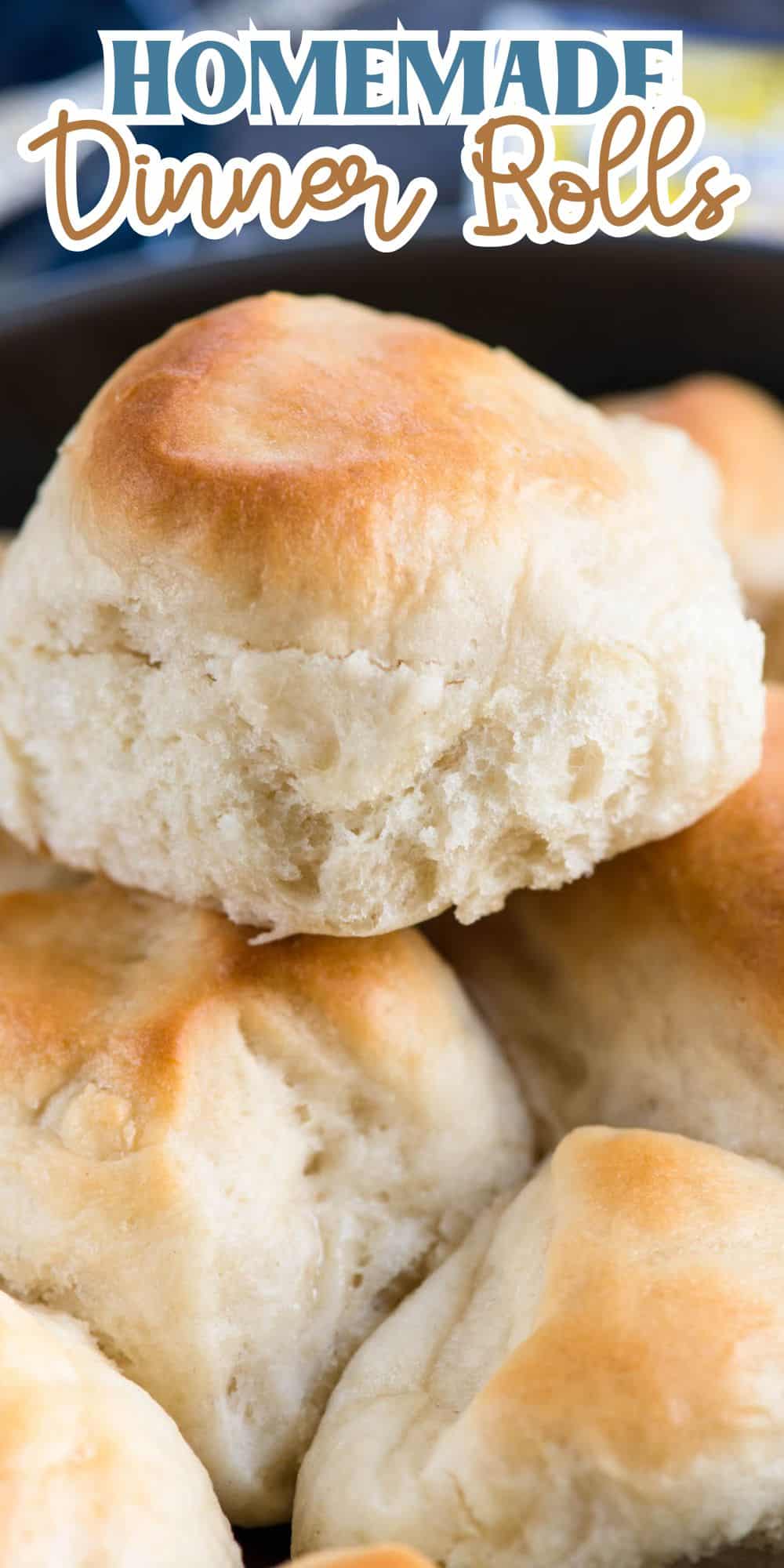 Close-up of a stack of homemade dinner rolls with a golden-brown crust and soft, fluffy interior. The image is topped with the text Homemade Dinner Rolls in a stylized font.