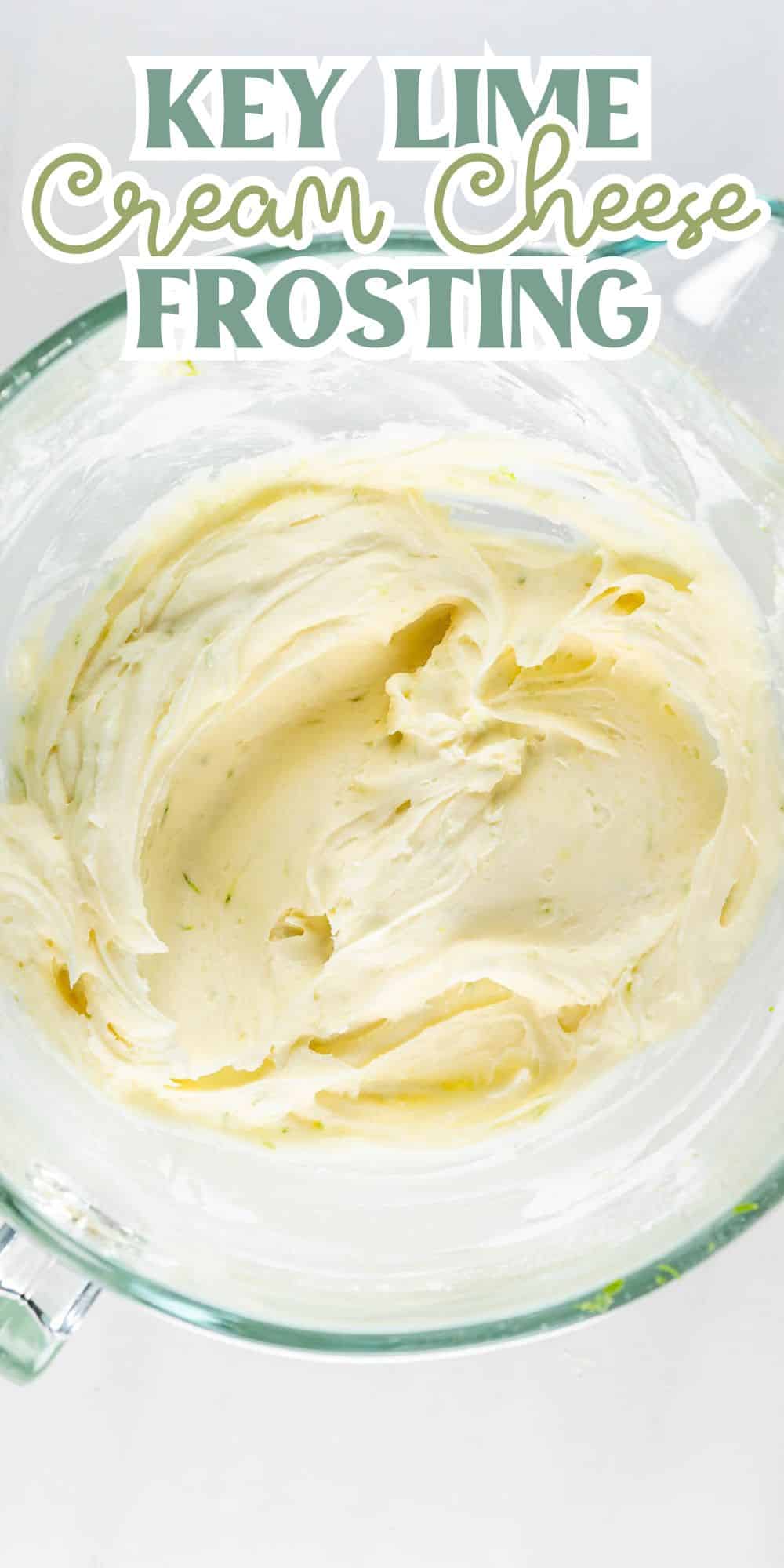 A glass bowl filled with creamy key lime cream cheese frosting. Text at the top reads Key Lime Cream Cheese Frosting. The frosting has a smooth texture and pale yellow color with green flecks.