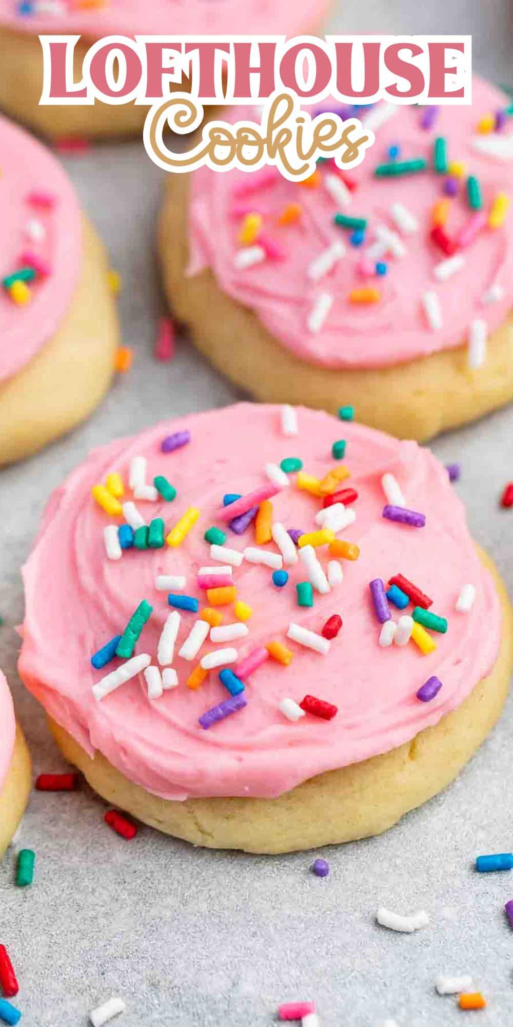 Close-up of Lofthouse-style cookies topped with pink frosting and colorful sprinkles, displayed on a light-colored surface. The words Lofthouse Cookies are written at the top in playful font.