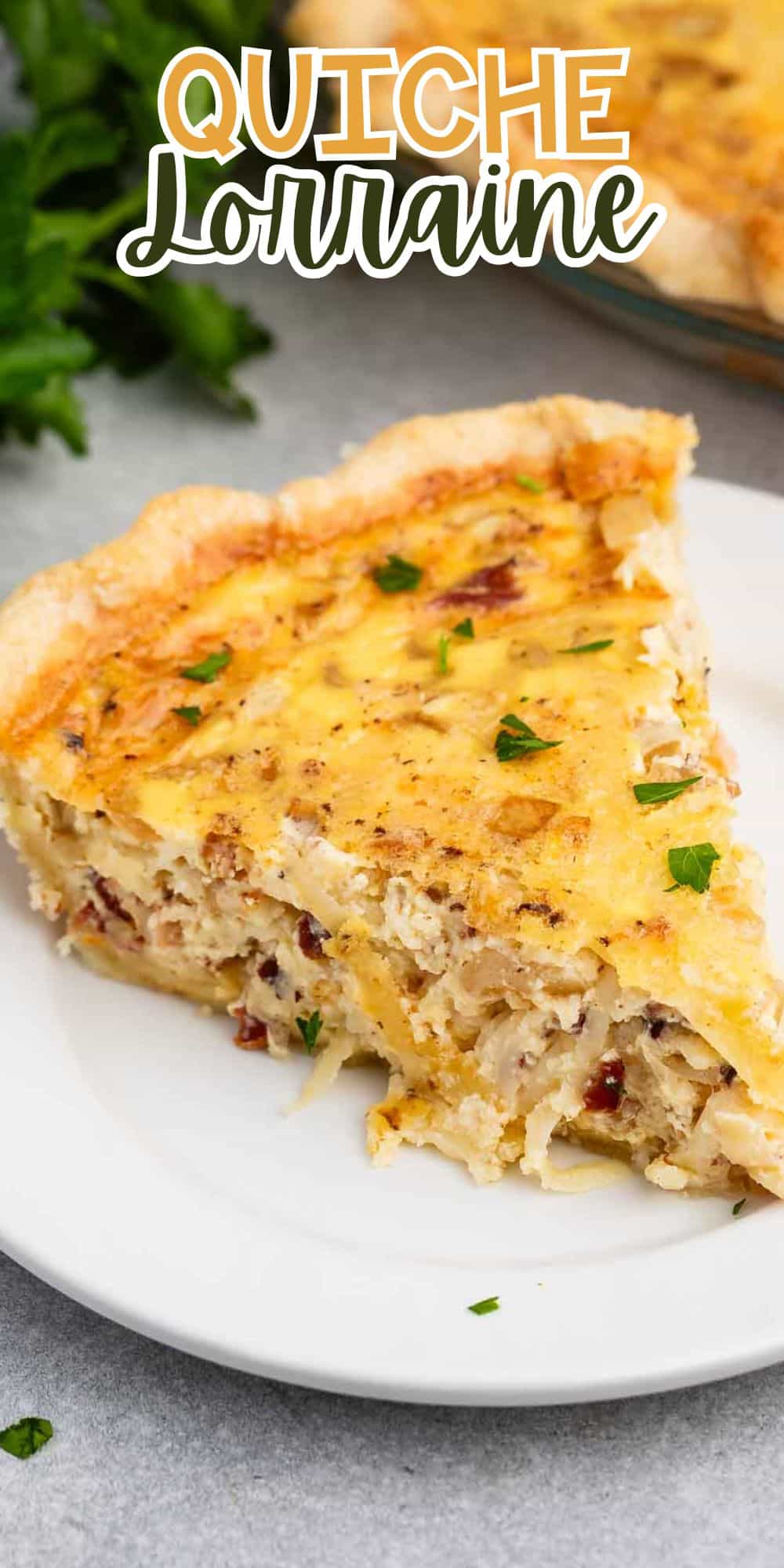 A slice of quiche on a white plate. The quiche is golden brown with visible bits of meat and herbs, garnished with parsley. Text at the top reads QUICHE Lorraine. Green parsley is in the background.