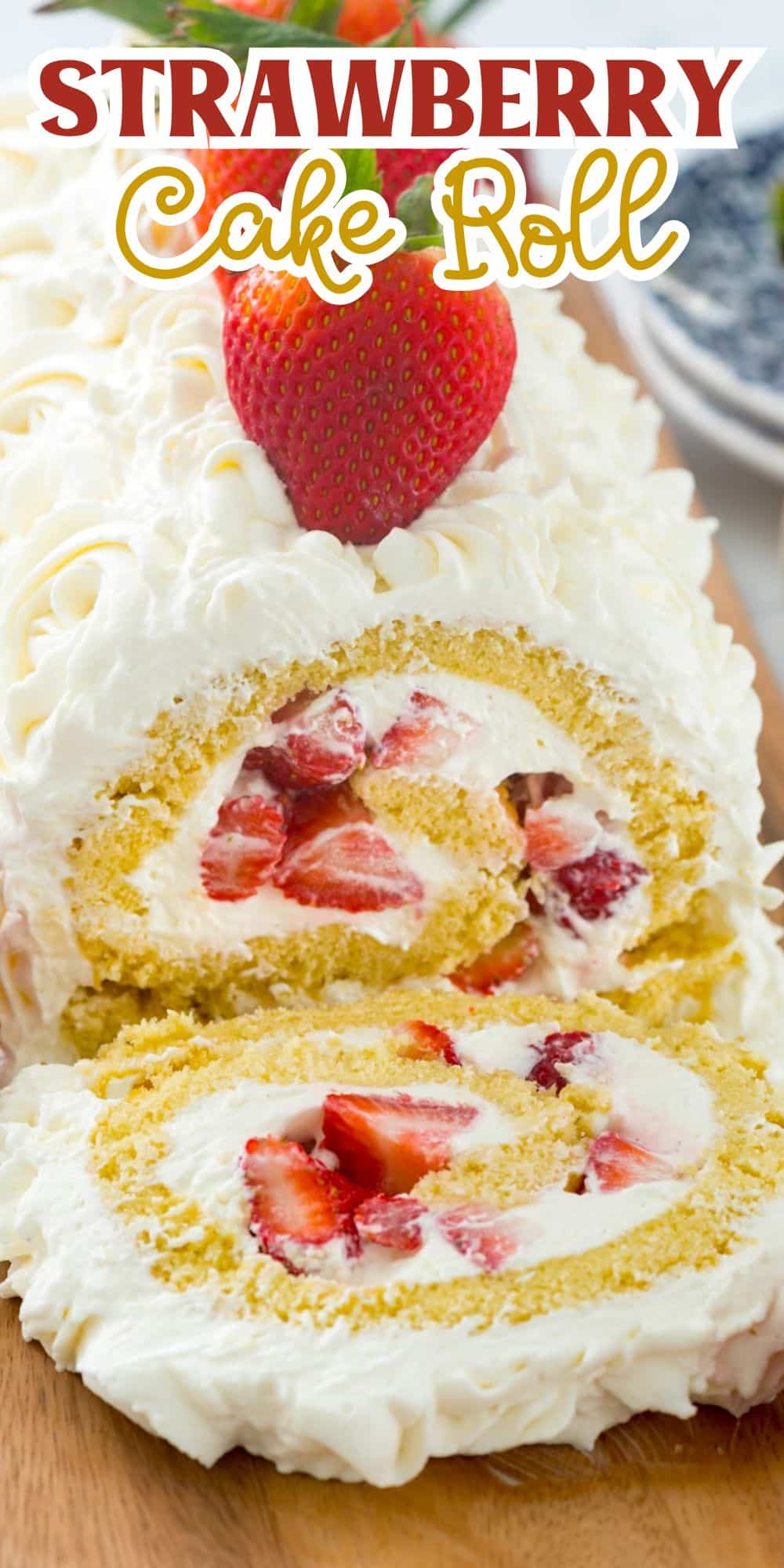 cake roll filled with strawberries and covered with white frosting on a cutting board with words on the image.