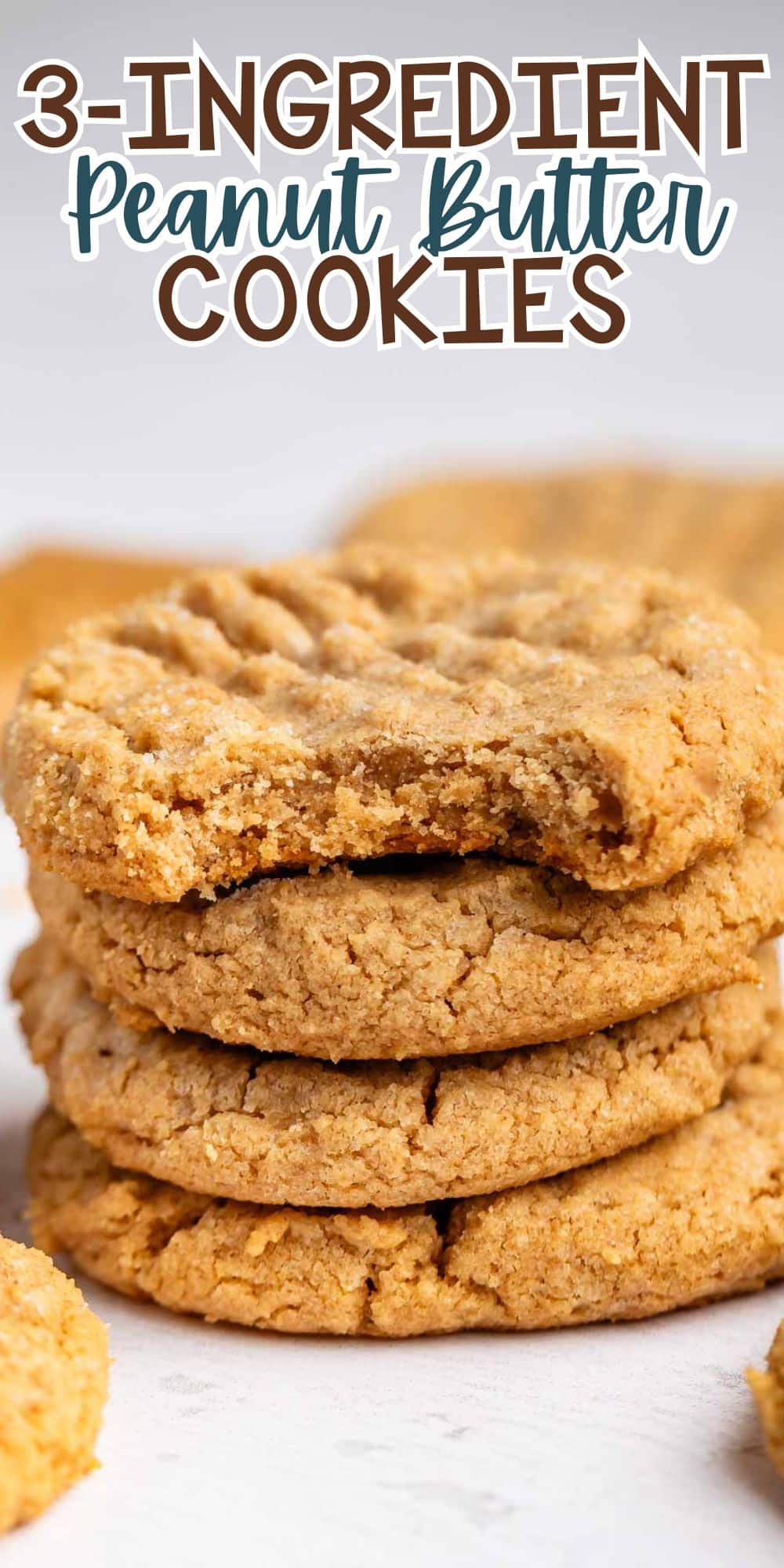 A stack of peanut butter cookies sits on a white surface with the text 3-Ingredient Peanut Butter Cookies above them. The cookies are golden brown and have a crisscross pattern on top.