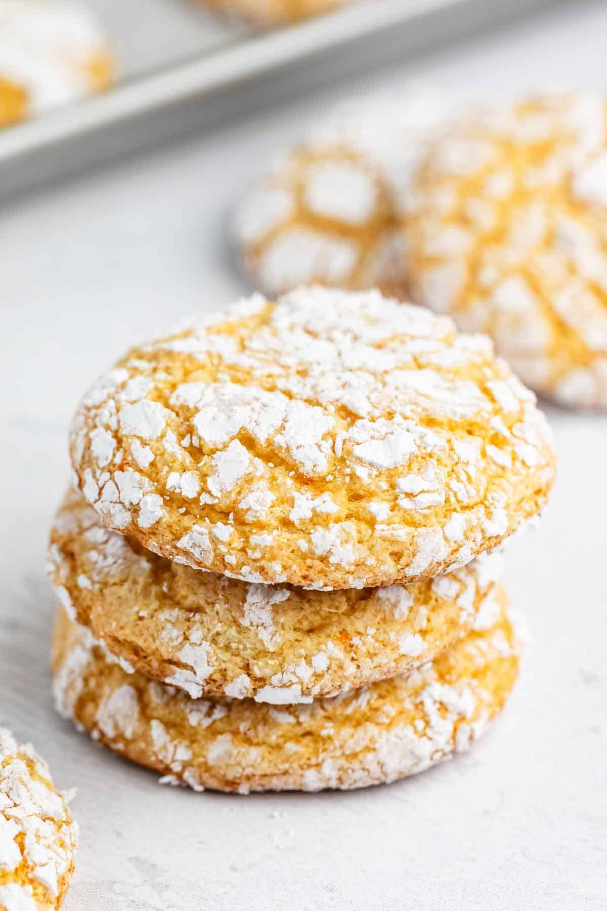 A stack of three crinkle cookies dusted with powdered sugar, labeled Cool Whip Cookies.