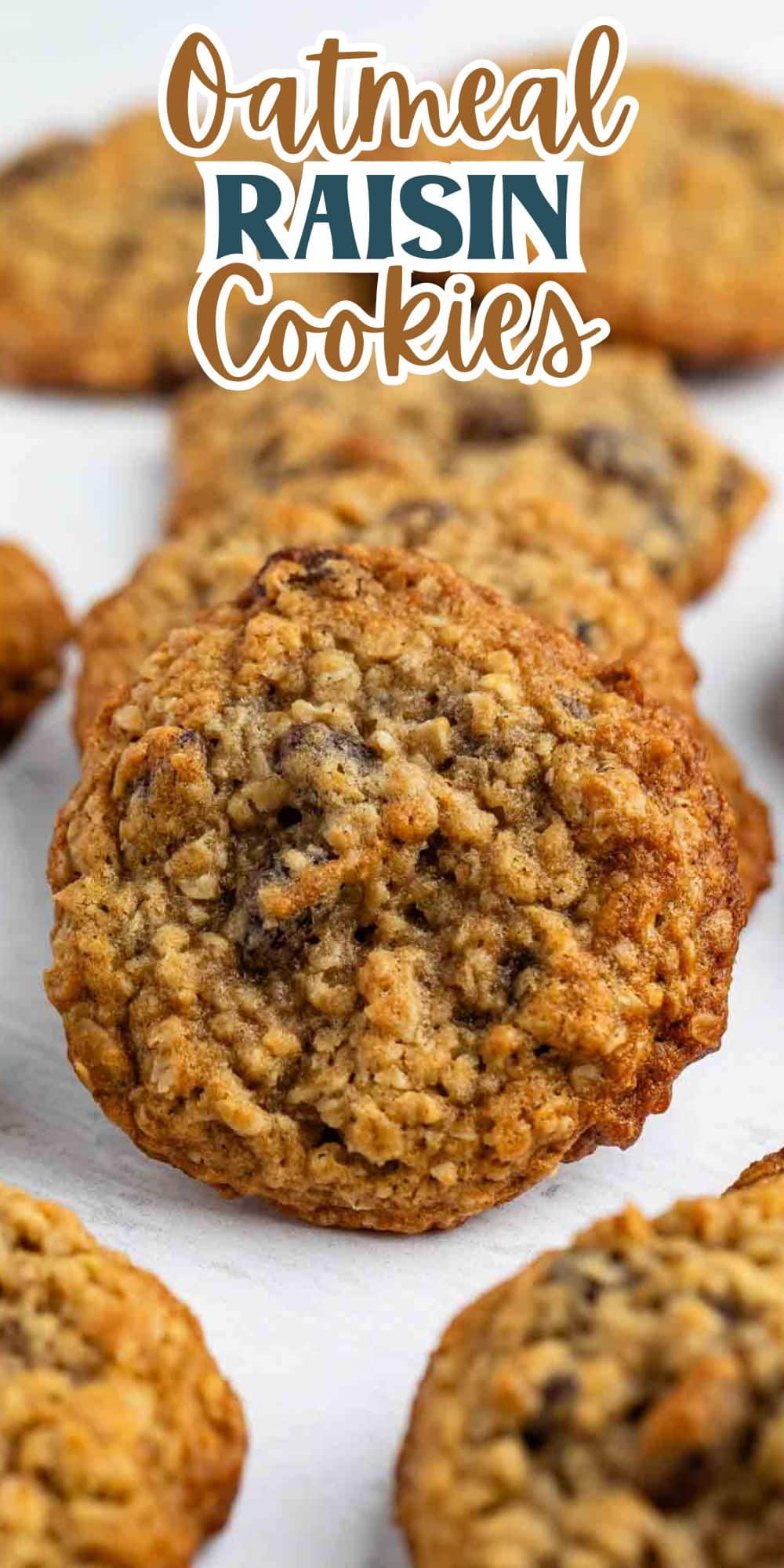 Close-up of oatmeal raisin cookies arranged neatly on a white surface. The cookies are golden-brown, showcasing a textured surface with visible oats and raisins. The words Oatmeal Raisin Cookies are written in stylized text at the top.
