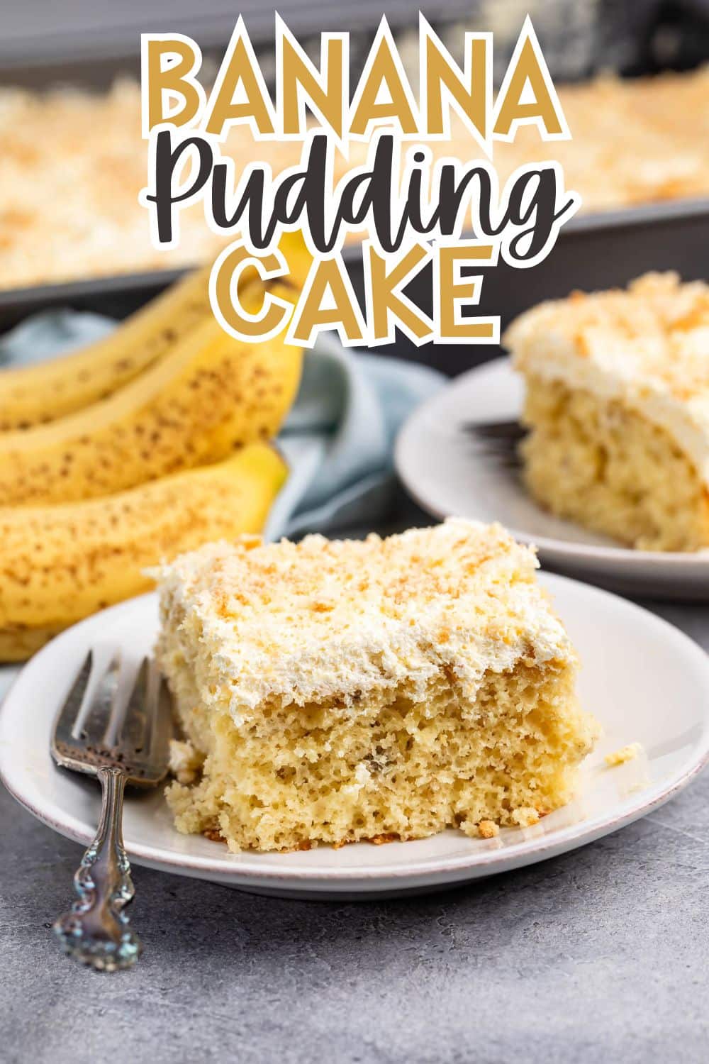 A square slice of banana pudding cake sits on a white plate with a fork. Behind it, more cake and ripe bananas are visible. The words Banana Pudding Cake are written at the top of the image.