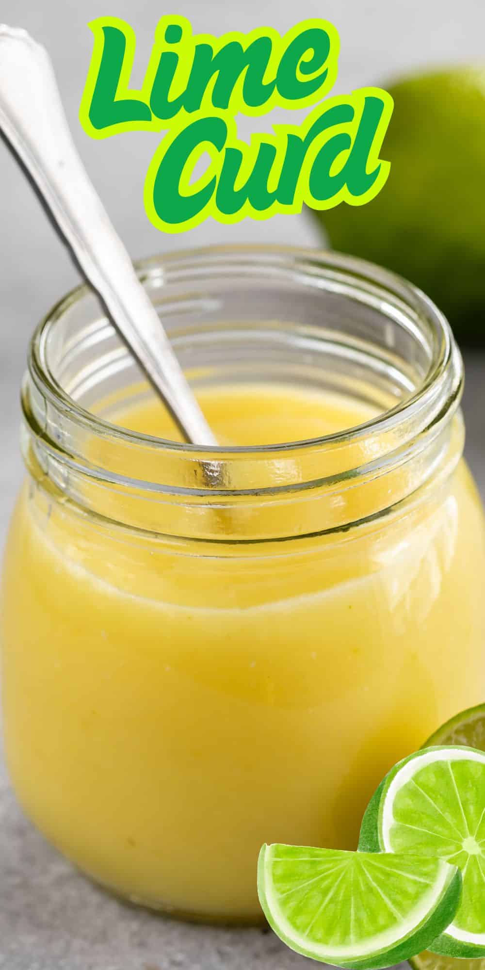 A glass jar filled with creamy yellow lime curd, with a spoon inside. Sliced limes and a whole lime are next to the jar. The text Lime Curd is written in bright green at the top.