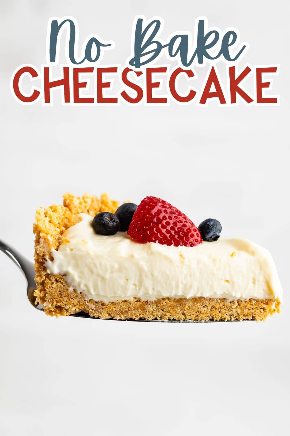 cheesecake topped with frosting, blueberries, and strawberries with the fruits also sprinkled around the cheesecake.