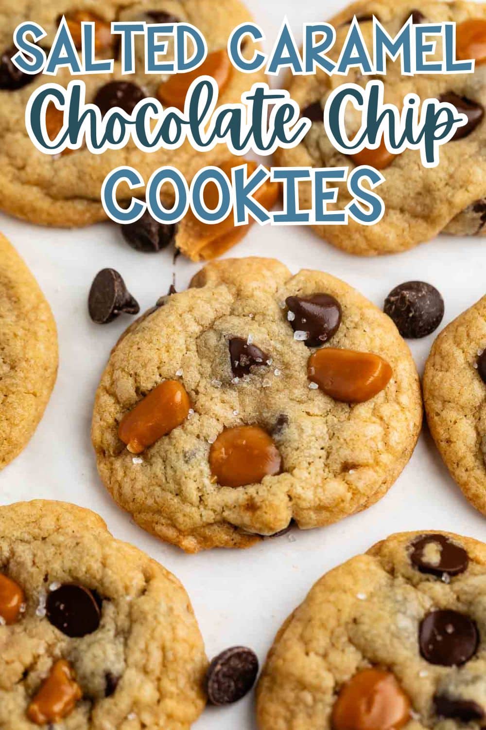 A close-up of salted caramel chocolate chip cookies on parchment paper, surrounded by scattered chocolate chips and caramel pieces. Text at the top reads “Salted Caramel Chocolate Chip Cookies.”.
