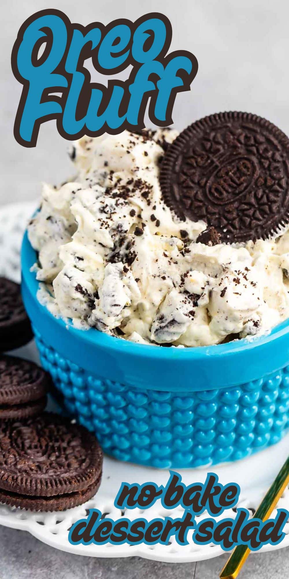 A bright blue bowl filled with Oreo fluff dessert, topped with crushed Oreo cookies and a whole Oreo. Extra Oreo cookies are on the side. The text reads Oreo Fluff and no-bake dessert salad.