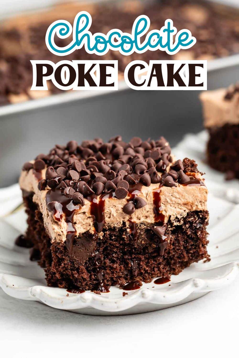 A slice of chocolate poke cake topped with chocolate cream, mini chocolate chips, and chocolate drizzle on a white plate, with more cake in the background. The text Chocolate Poke Cake appears above the cake.