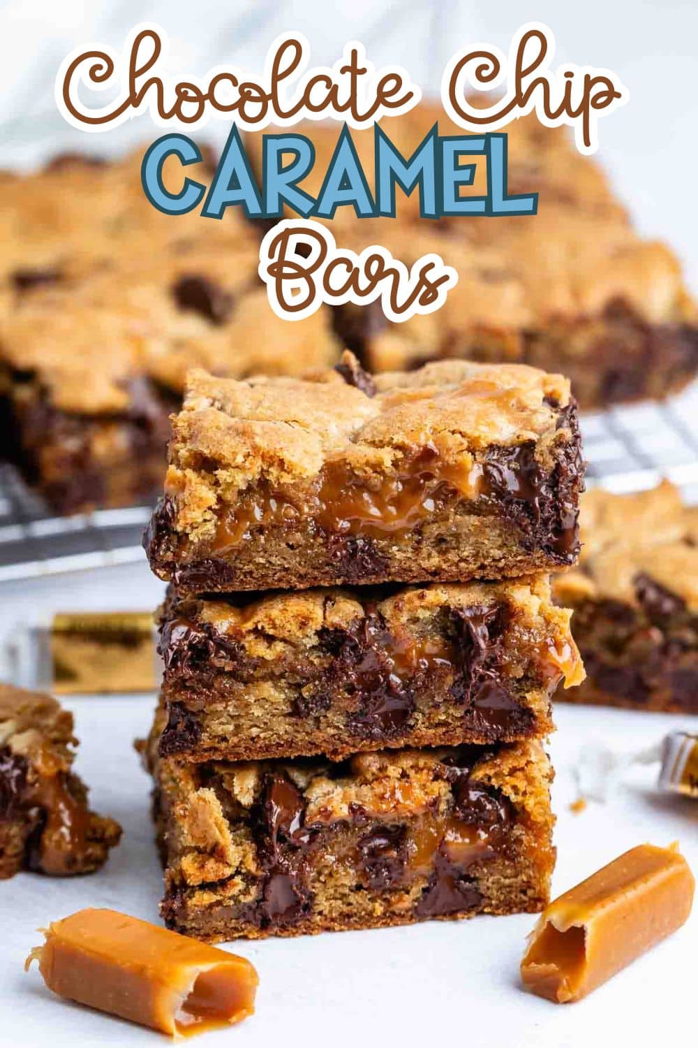 A stack of gooey chocolate chip caramel bars sits in front of a cooling rack with more bars. Chocolate chips and melted caramel are visible in the bars, and unwrapped caramel candies are nearby. Text reads Chocolate Chip Caramel Bars.