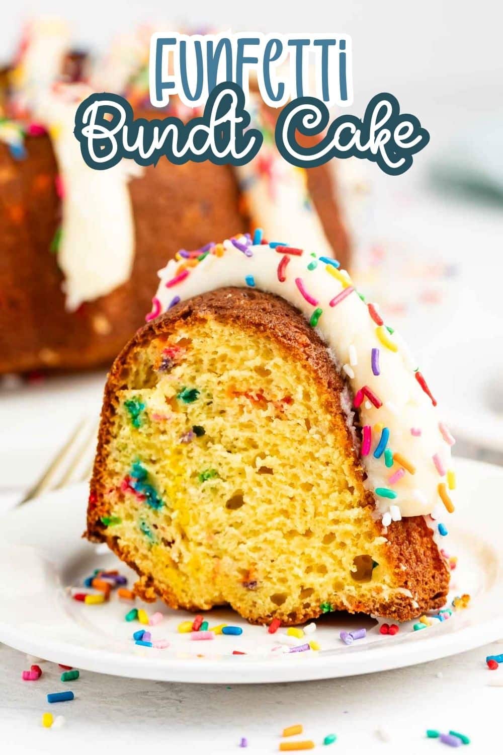 A slice of funfetti bundt cake with colorful sprinkles and white icing sits on a white plate, with more cake and sprinkles visible in the background. Text above reads “Funfetti Bundt Cake.”.