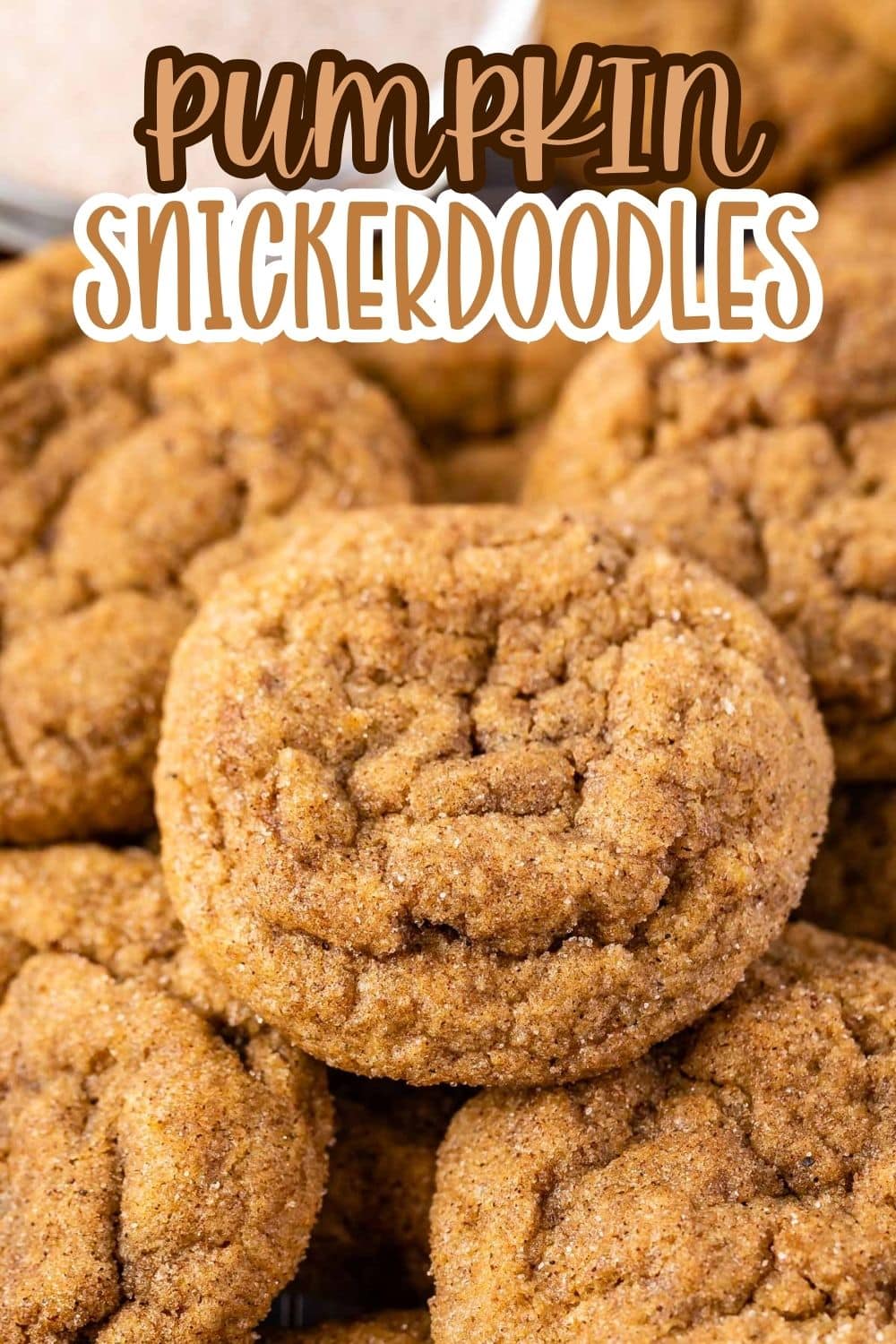 A close-up of a stack of pumpkin snickerdoodle cookies with a soft, crinkly texture. Text over the image reads Pumpkin Snickerdoodles in bold, playful lettering.