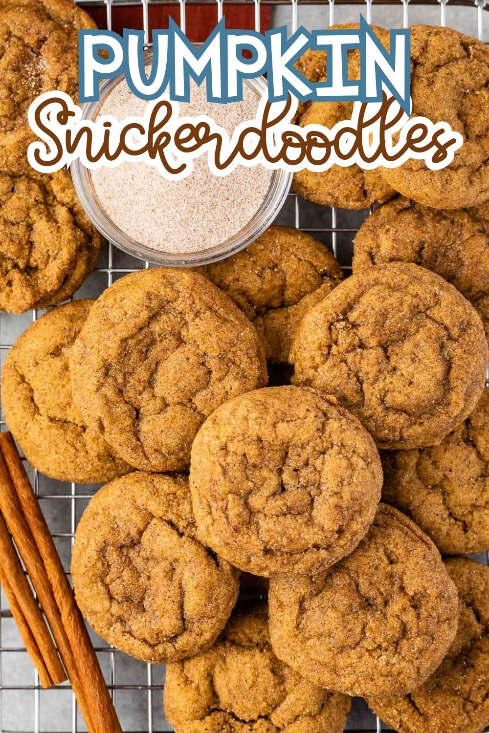 Pumpkin snickerdoodle cookies arranged on a cooling rack with a small bowl of cinnamon sugar and cinnamon sticks beside them. Text at the top reads “Pumpkin Snickerdoodles.”.