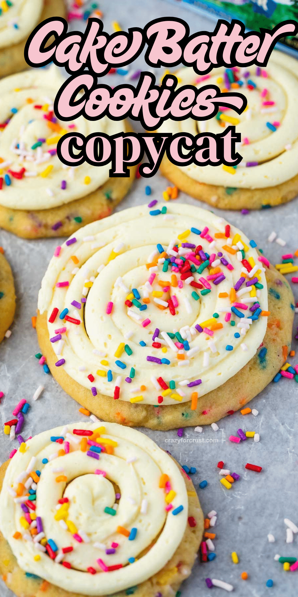 Close-up of frosted cookies with colorful rainbow sprinkles on top, arranged on a white surface. The text on the image says Cake Batter Cookies copycat in bold, playful lettering.