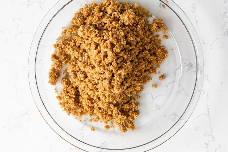 glass pie plate with graham cracker crust crumbs.