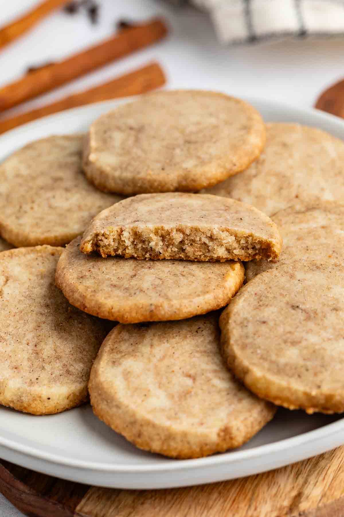 stacked brown chai cookies on a grey plate.