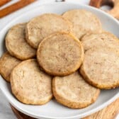 stacked brown chai cookies on a grey plate.