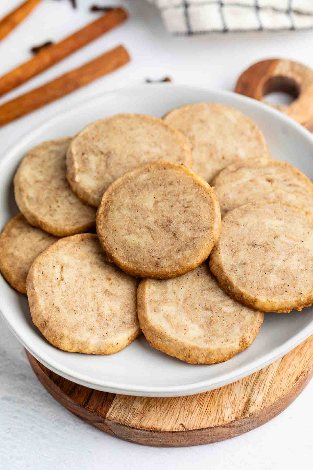 stacked brown chai cookies on a grey plate.