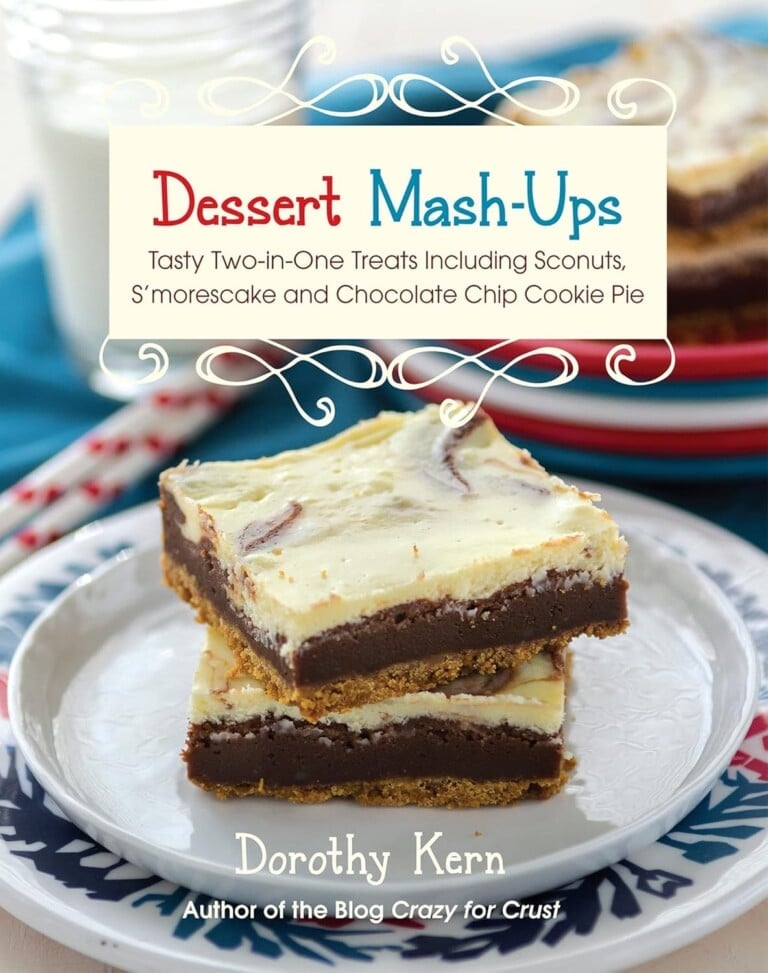 The cover of the cookbook Dessert Mash-Ups by Dorothy Kern, featuring two stacked dessert bars with a creamy top and chocolate layer, on a plate, with milk and plates in the background.