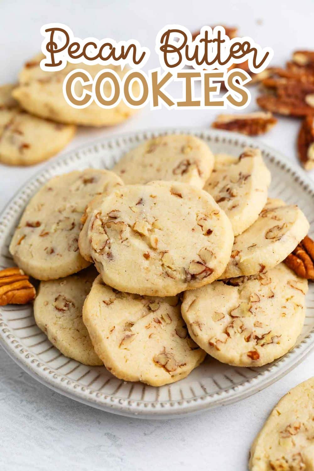 sliced cookies with pecans baked in and laid out on a grey plate with words on the image reading the name of the recipe.