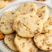 sliced cookies with pecans baked in and laid out on a grey plate.