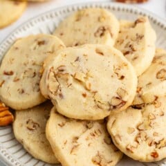 sliced cookies with pecans baked in and laid out on a grey plate.