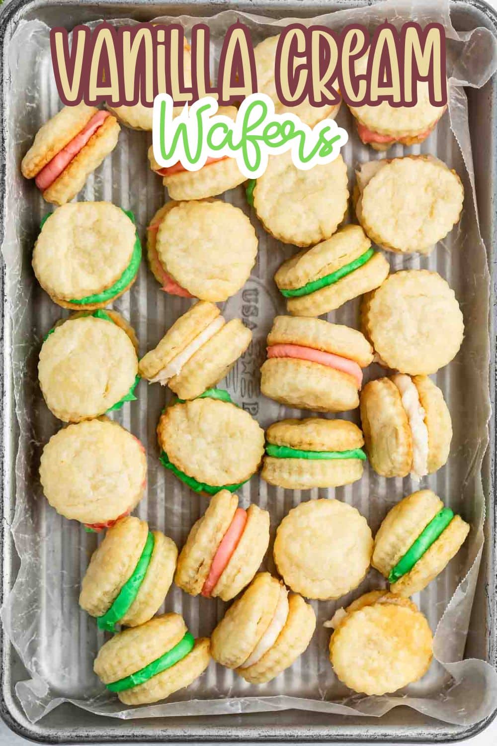 A tray filled with round vanilla cream wafer cookies, some with pink, green, or white filling. The text Vanilla Cream Wafers is displayed at the top of the image.