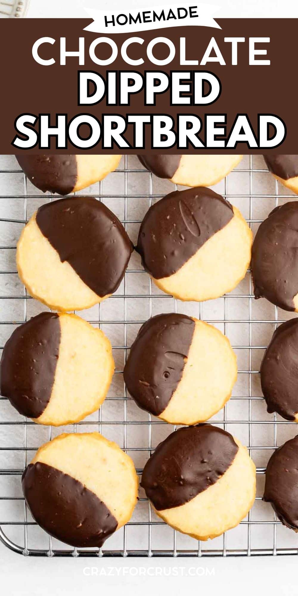 Round shortbread cookies, half-dipped in chocolate, are arranged on a wire cooling rack. The text above the cookies reads, “Homemade Chocolate Dipped Shortbread.”.