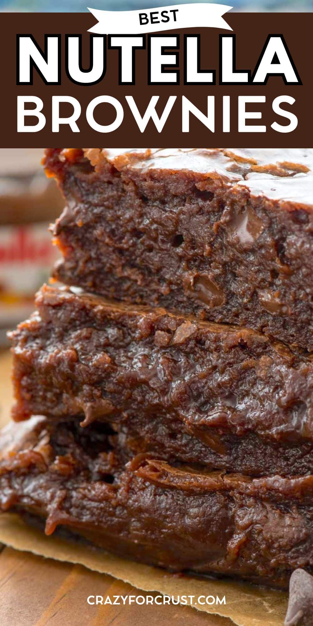 Close-up of three thick, fudgy Nutella brownies stacked on top of each other, showing a rich, gooey texture. The top banner reads “Best Nutella Brownies” and the bottom shows the website crazyforcrust.com.