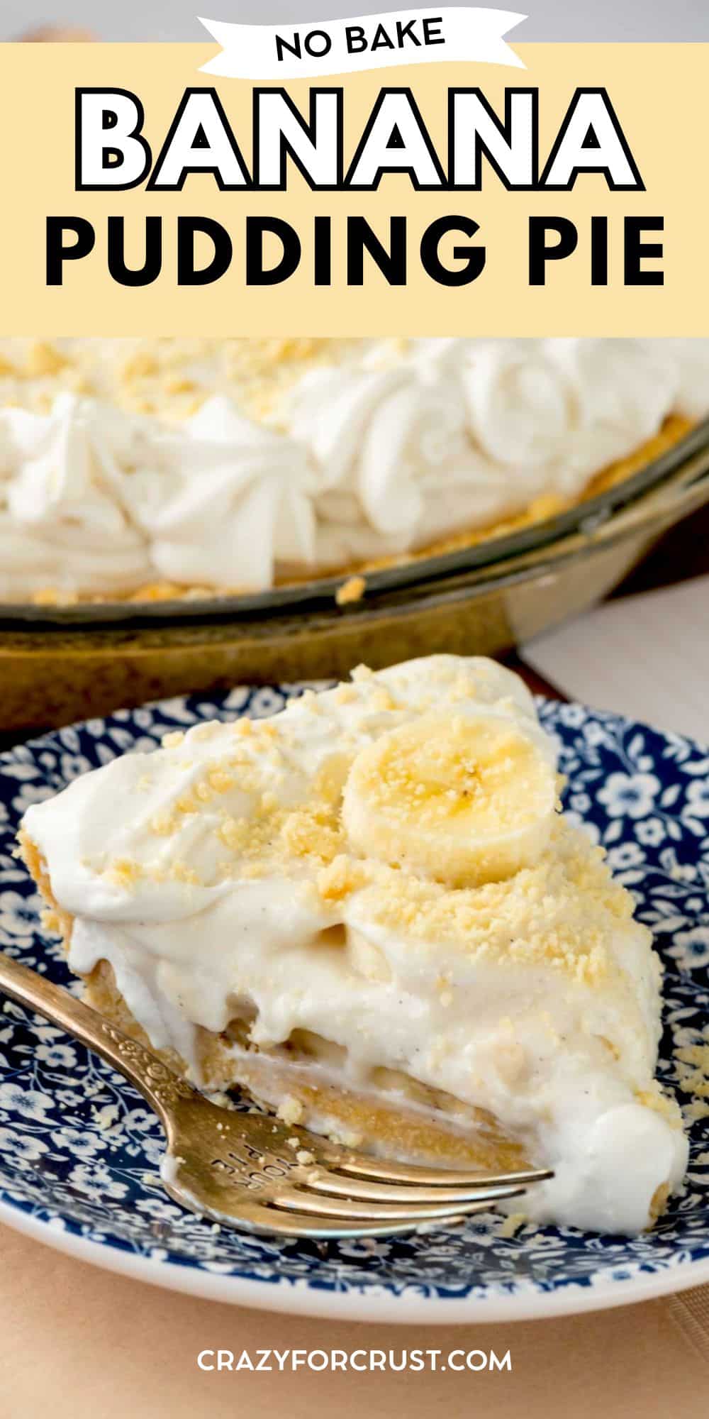 A slice of no-bake banana pudding pie topped with banana slices and crumbs sits on a blue patterned plate with a fork. The remaining pie is visible in the background. Text overlay reads No Bake Banana Pudding Pie.