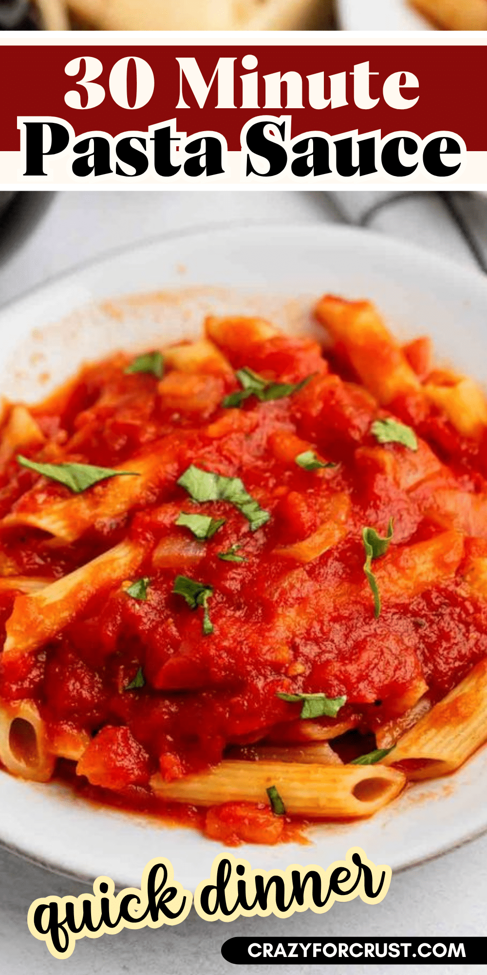 A plate of penne pasta topped with tomato sauce and garnished with chopped fresh basil. Text reads “30 Minute Pasta Sauce” and “quick dinner” with the website crazyforcrust.com at the bottom.