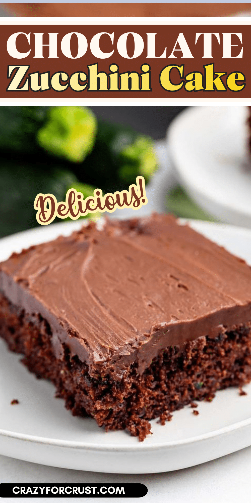 A slice of chocolate zucchini cake with chocolate frosting sits on a white plate. The cake looks moist and rich, with visible zucchini in the background. Text reads: Chocolate Zucchini Cake and Delicious!.