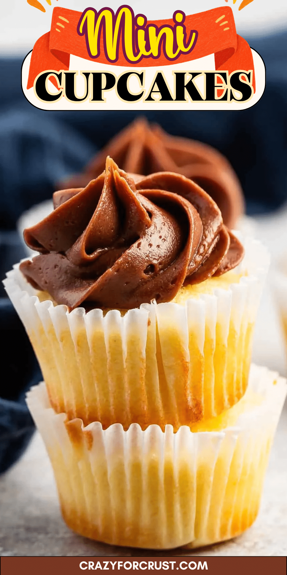 Two vanilla mini cupcakes stacked on top of each other, each topped with a swirl of rich chocolate frosting. The image has text reading Mini Cupcakes at the top and crazyforcrust.com at the bottom.