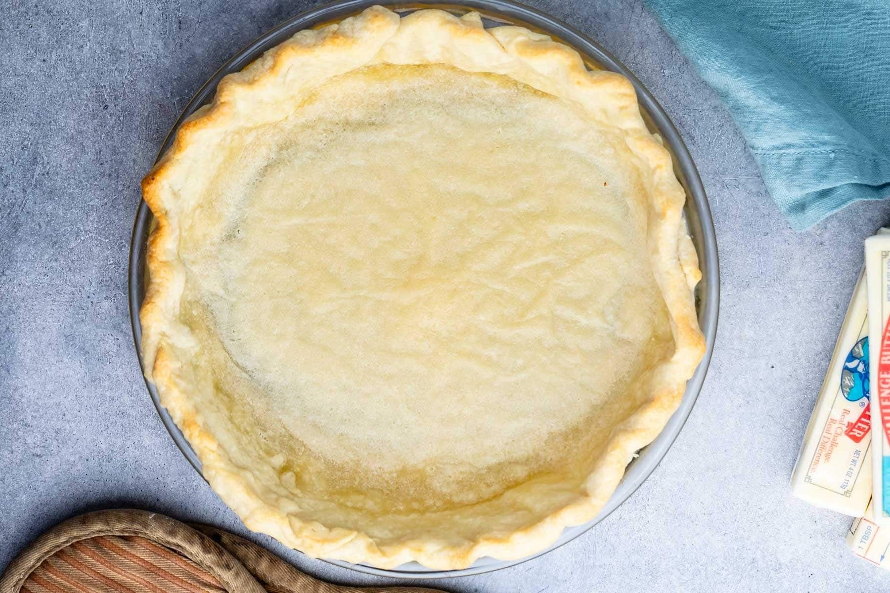 butter pie crust in a clear pan.