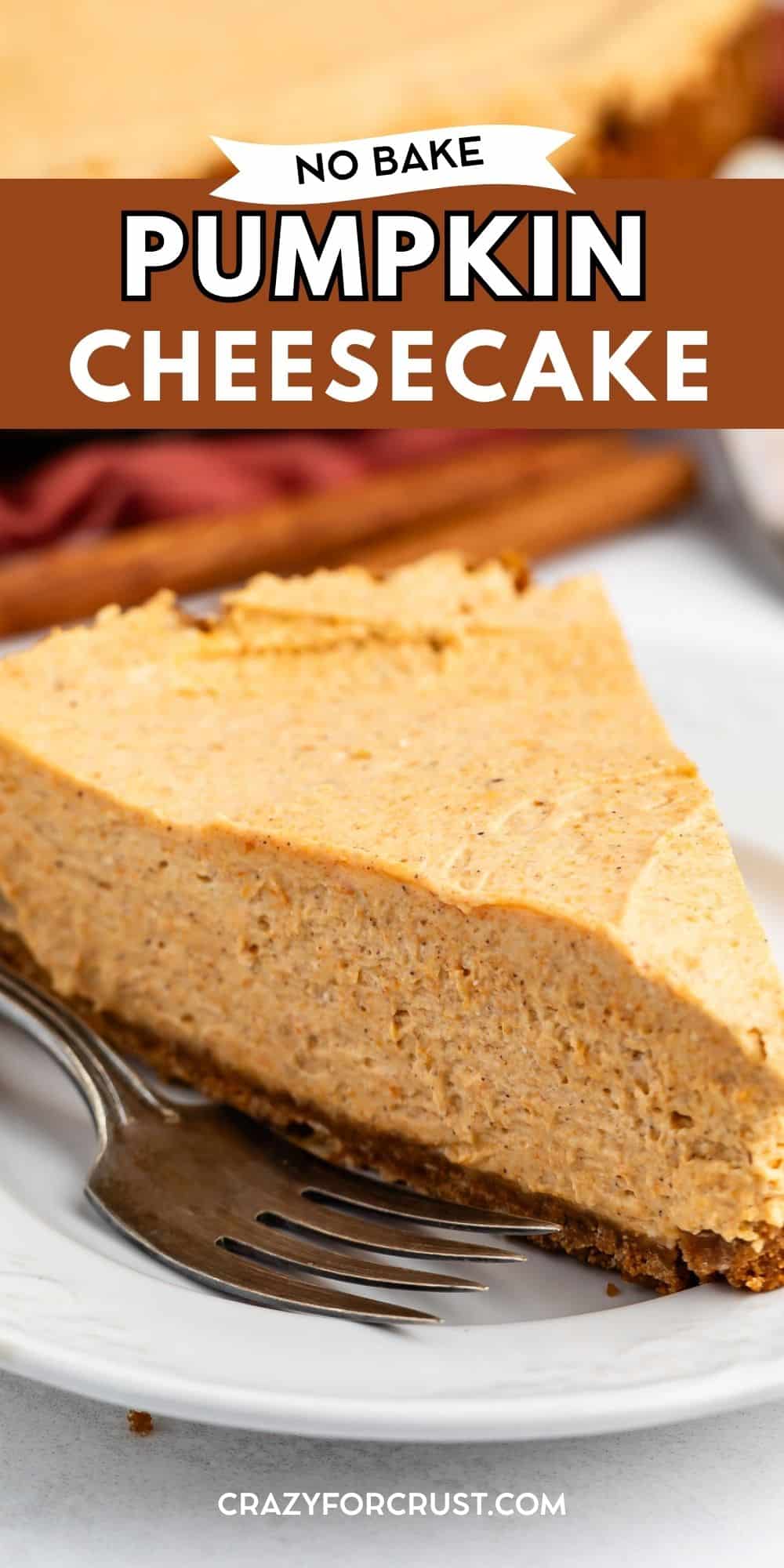 A slice of creamy no-bake pumpkin cheesecake sits on a white plate with a fork beside it. The cheesecake has a spiced orange filling and a graham cracker crust.